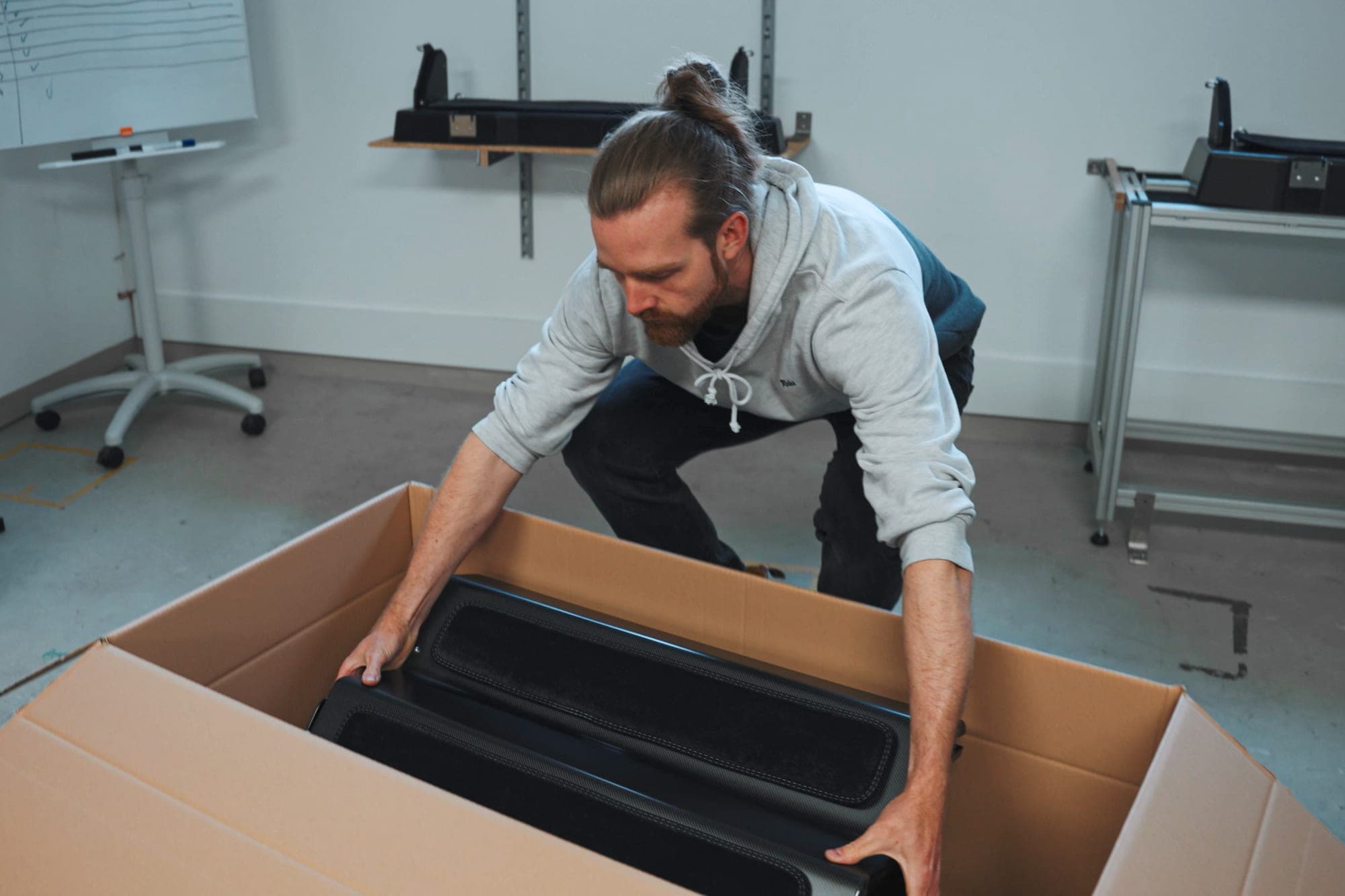 A Dog&Drive team member packing folded carbon-fibre Dog Steps into a delivery carton