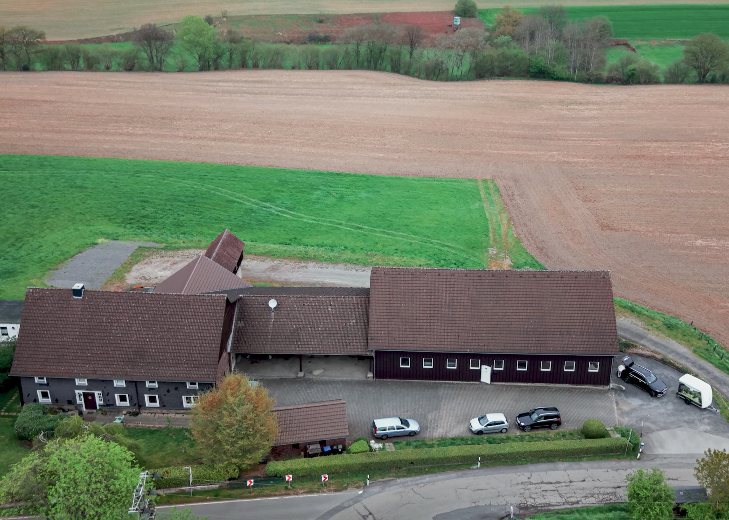 Aerial view of the Dog&Drive workshop buildings among fields in Odenthal, Germany.